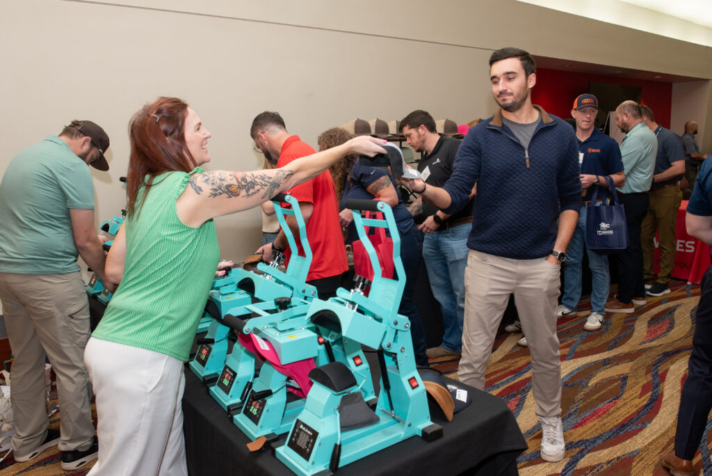 Hat Bar of Georgia team member pressing custom patch hats live for guests at a corporate event