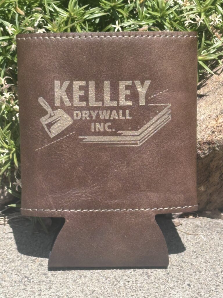 Brown leather can holder engraved with the Kelley Drywall Inc. logo, a custom branded promo item
