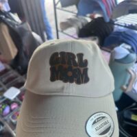 Stone dad hat with a Girl Mom patch in dark bubble letters