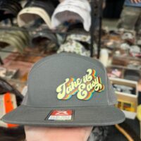 Charcoal trucker hat with a retro rainbow Take It Easy patch